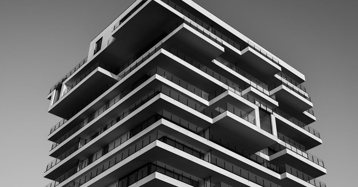 A striking black and white photo of a modern high-rise building with unique geometric designs.
